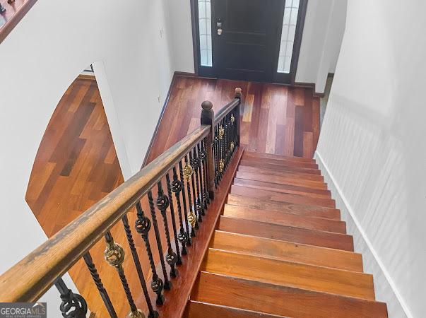 staircase featuring hardwood / wood-style flooring