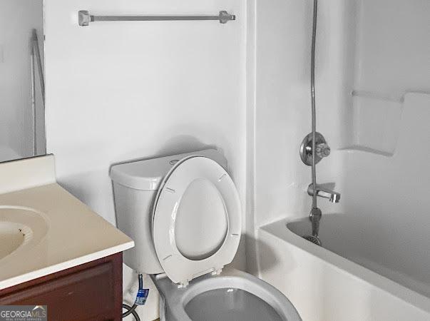 full bathroom featuring vanity, toilet, and shower / washtub combination