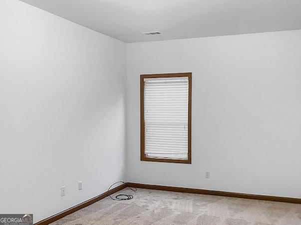 empty room with light colored carpet