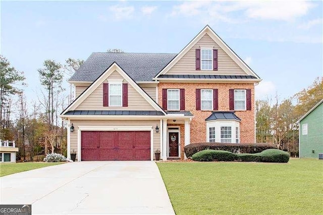 view of front of house with a garage and a front yard