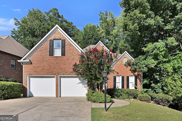 front facade featuring a front yard and a garage