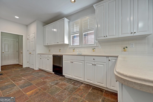 kitchen with white cabinets, backsplash, and black dishwasher