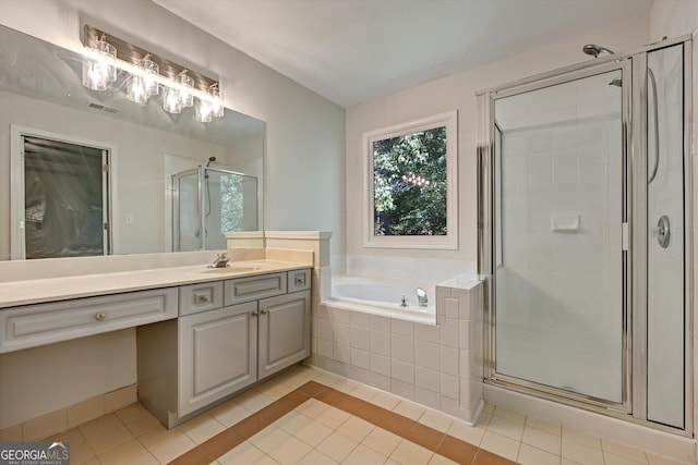 bathroom featuring tile patterned floors, vanity, and plus walk in shower