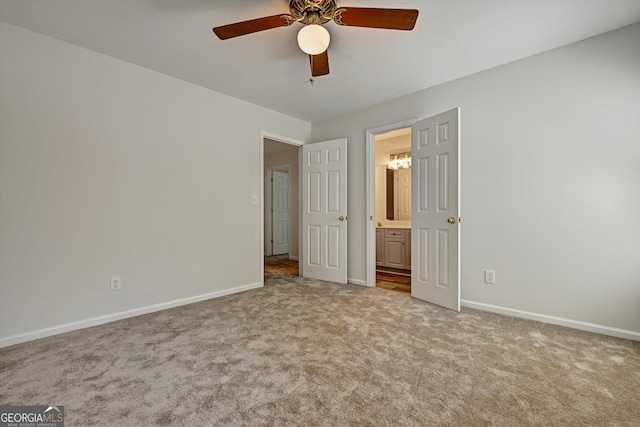 unfurnished bedroom with ceiling fan, ensuite bathroom, and light carpet