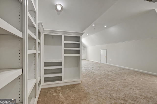 spacious closet with carpet and lofted ceiling