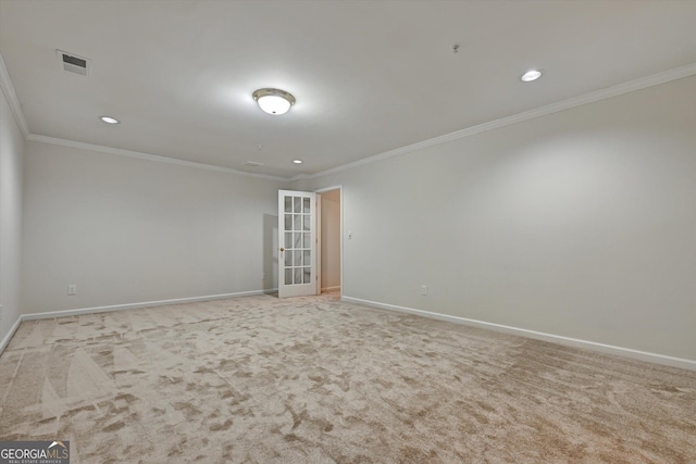 empty room with crown molding, light carpet, and french doors