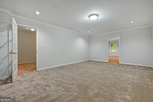 empty room with light colored carpet and ornamental molding