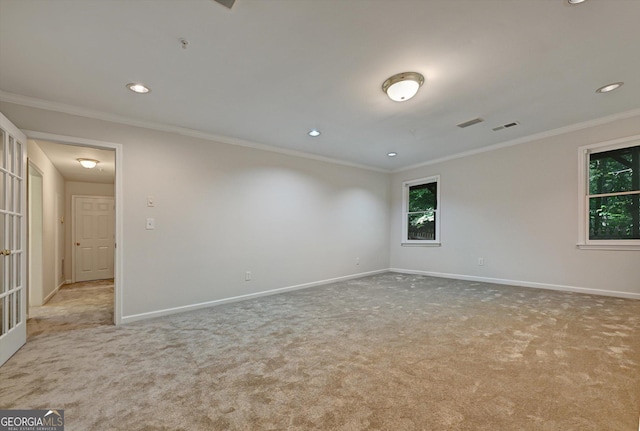 unfurnished room with light colored carpet and crown molding