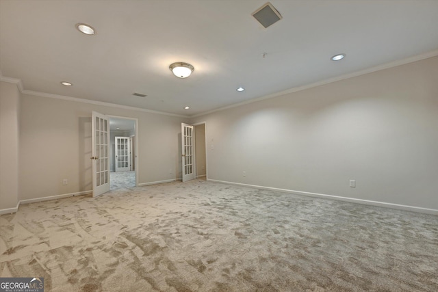 unfurnished room featuring light carpet, french doors, and crown molding