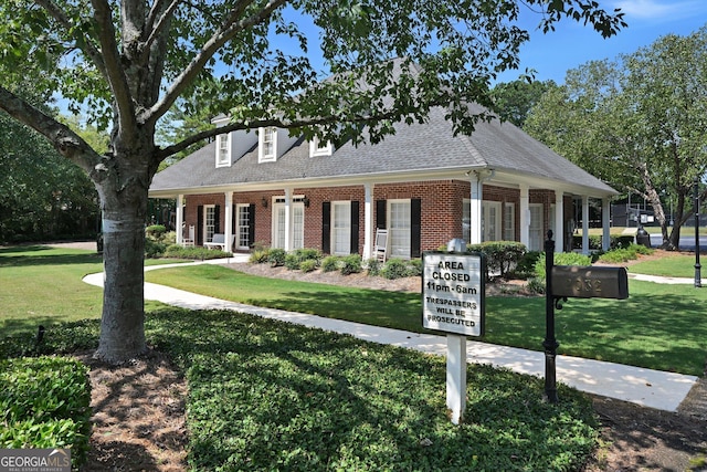 cape cod-style house featuring a front yard