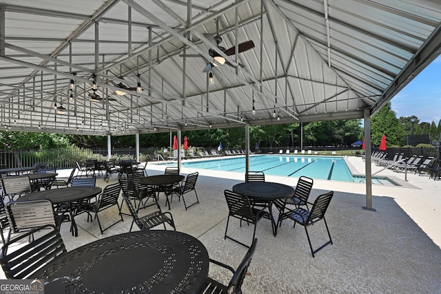 view of swimming pool with ceiling fan and a patio