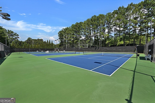 view of tennis court with basketball hoop