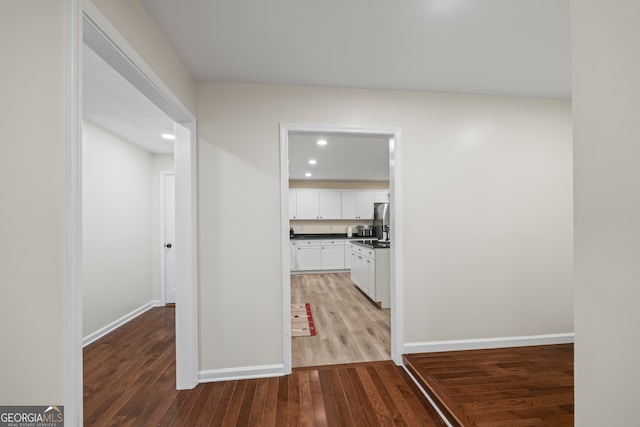 corridor with wood-type flooring