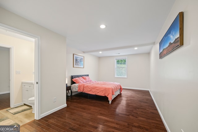 bedroom featuring connected bathroom and dark hardwood / wood-style floors