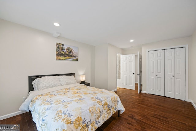 bedroom with a closet and dark hardwood / wood-style floors