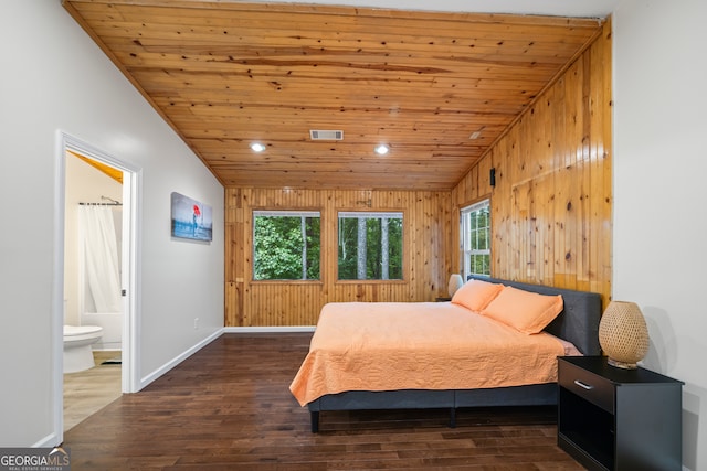 bedroom featuring wood ceiling, connected bathroom, wooden walls, and dark wood-type flooring