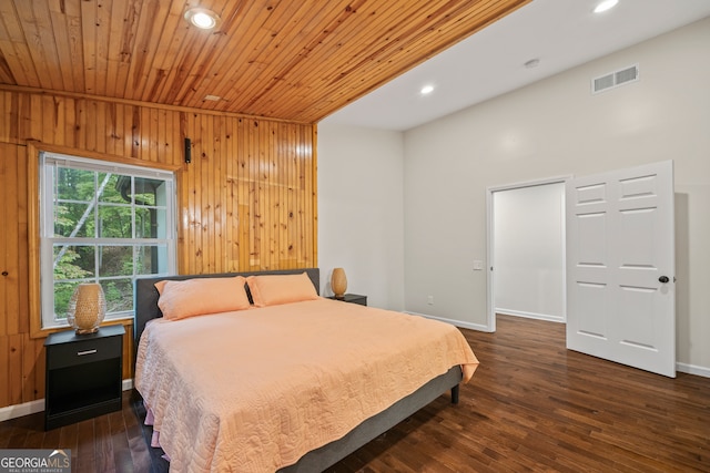 bedroom with wooden ceiling, dark wood-type flooring, and wooden walls