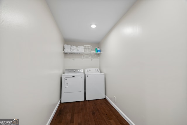 laundry area with washing machine and dryer and dark wood-type flooring