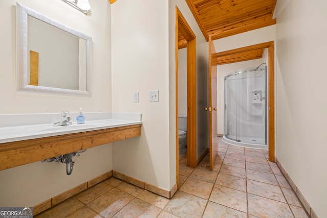 bathroom featuring a shower with door, sink, wooden ceiling, tile patterned flooring, and toilet