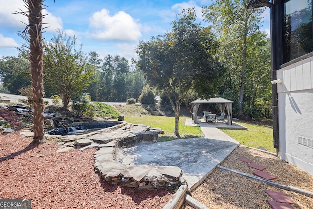 view of yard with a gazebo and a patio