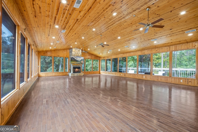 unfurnished sunroom with ceiling fan, lofted ceiling, a fireplace, and wooden ceiling