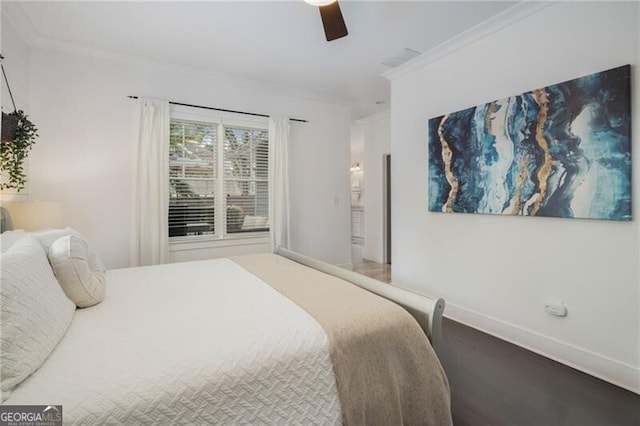 bedroom featuring ceiling fan, hardwood / wood-style flooring, and ornamental molding