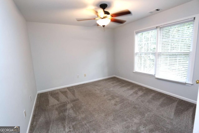 carpeted empty room featuring ceiling fan