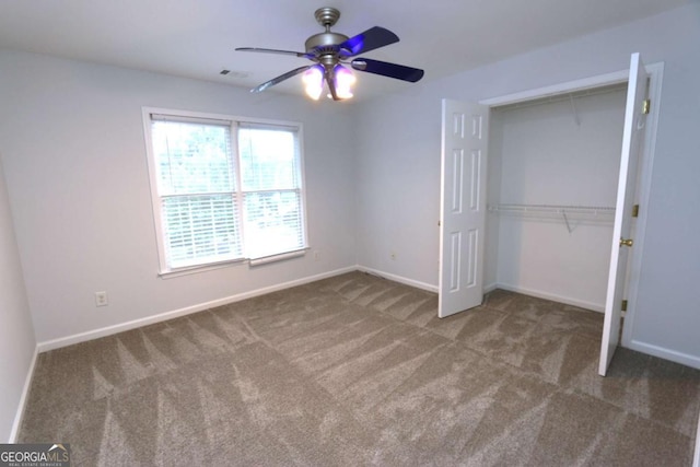 unfurnished bedroom with ceiling fan, a closet, and carpet floors