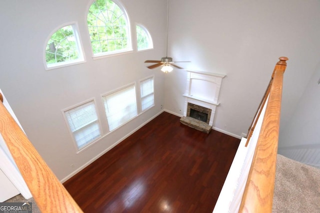 living room with ceiling fan, dark hardwood / wood-style flooring, and a fireplace