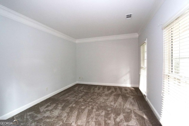 spare room featuring dark carpet and crown molding