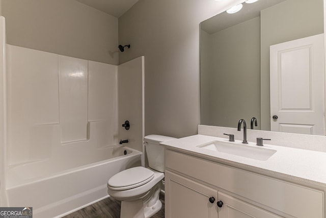 full bathroom featuring vanity, hardwood / wood-style floors,  shower combination, and toilet