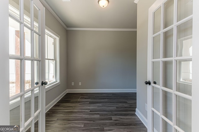 unfurnished room featuring dark wood-type flooring and crown molding