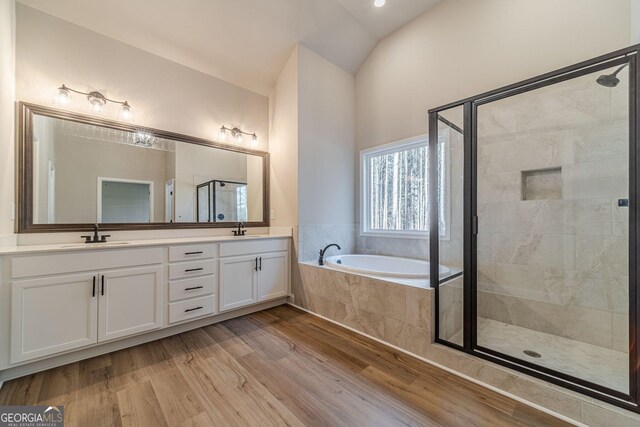 full bathroom featuring hardwood / wood-style floors, vanity, toilet, and shower / tub combination