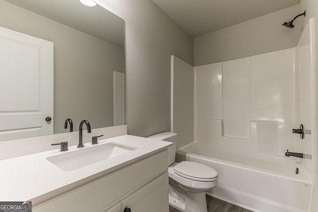 full bathroom with hardwood / wood-style flooring, vanity, toilet, and shower / bath combination