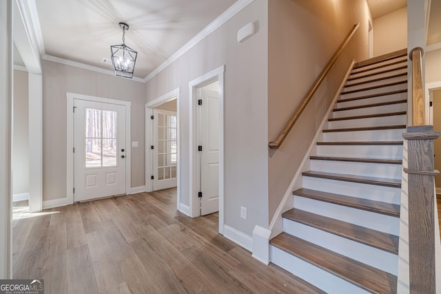 unfurnished dining area with a fireplace, dark wood-type flooring, ceiling fan with notable chandelier, and ornamental molding