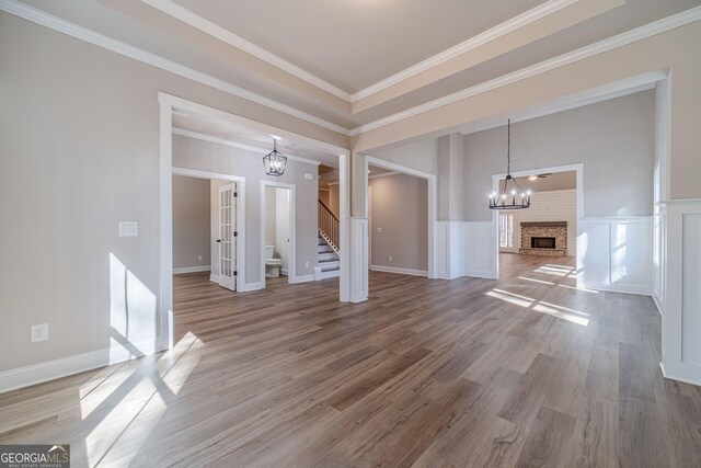 unfurnished living room featuring crown molding and dark wood-type flooring