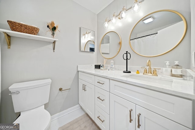 bathroom with curtained shower, tile patterned flooring, vanity, and toilet