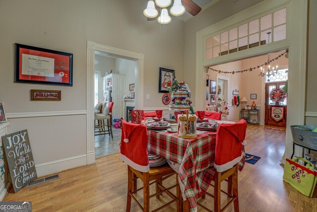 dining area featuring wood-type flooring and an inviting chandelier