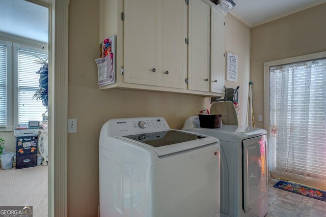 laundry room with cabinets, carpet, washer and clothes dryer, and ornamental molding