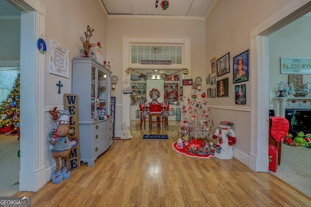 game room with ornamental molding and wood finished floors