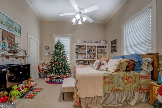 carpeted bedroom with ceiling fan and ornamental molding