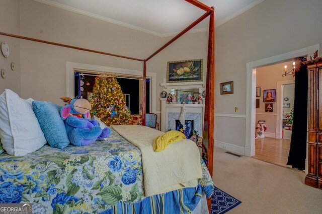 bedroom featuring a high end fireplace, crown molding, carpet floors, and lofted ceiling