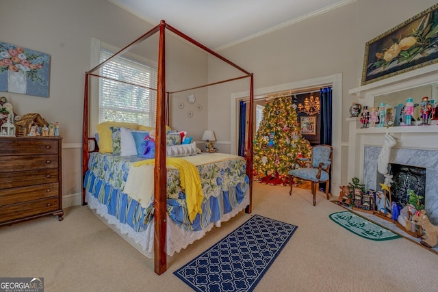 carpeted bedroom featuring ornamental molding and a fireplace