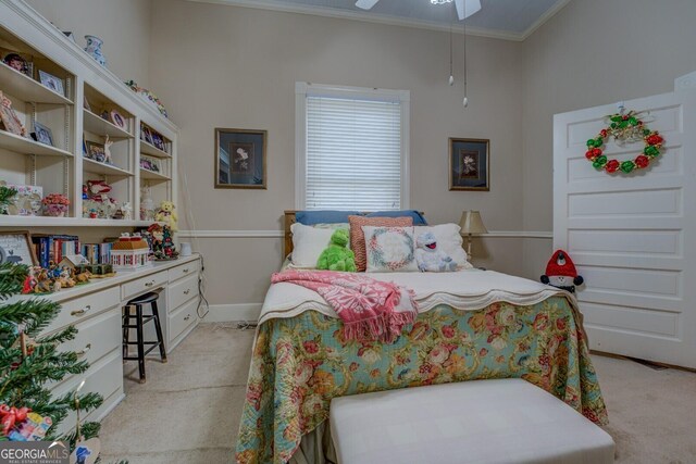 carpeted bedroom with ceiling fan and crown molding