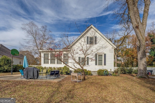 back of house featuring a yard and a patio