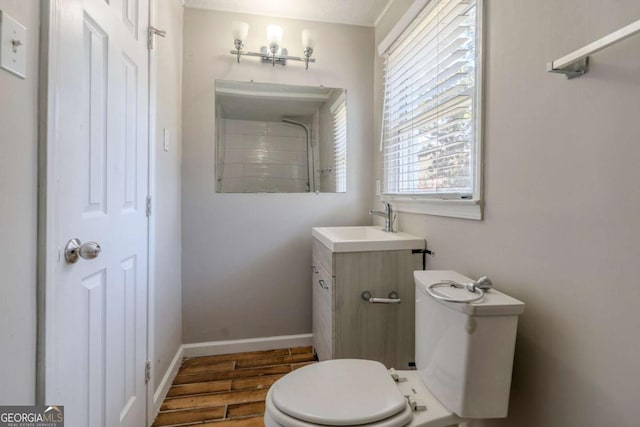 bathroom featuring vanity, wood-type flooring, and toilet