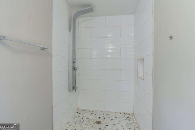 bathroom with tiled shower