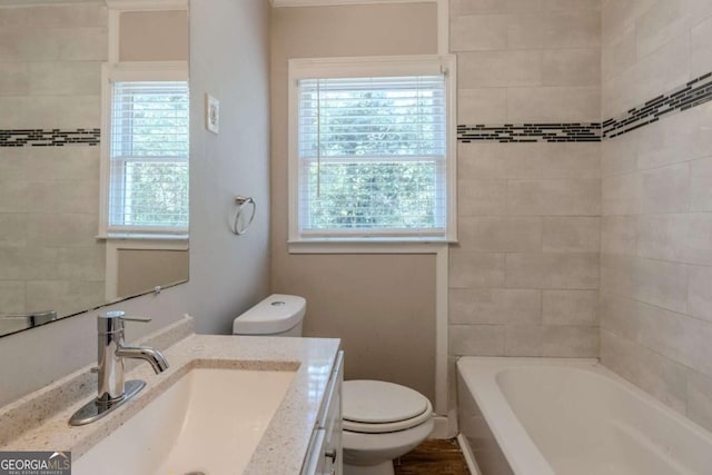 full bathroom with vanity, toilet, plenty of natural light, and tiled shower / bath combo