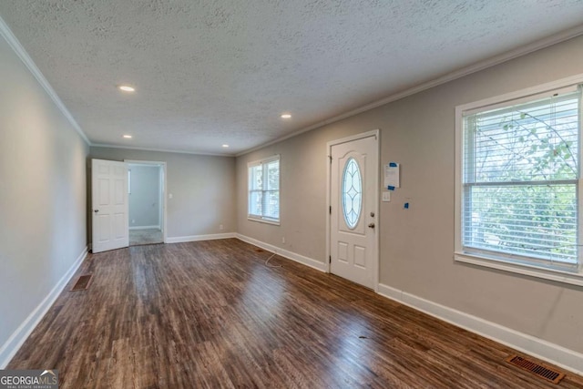 entrance foyer with a textured ceiling, dark hardwood / wood-style floors, and crown molding