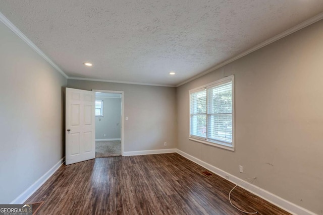 empty room with a textured ceiling, dark hardwood / wood-style floors, and ornamental molding